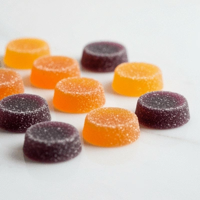 Assortment of colorful CBD gummies on a clean, modern surface with natural light, no text, no words, no typography, 8K