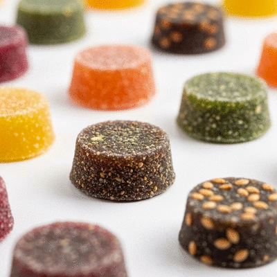 Assortment of colorful CBD gummies on a clean white background, focus on texture and natural ingredients, no text, no words, no typography