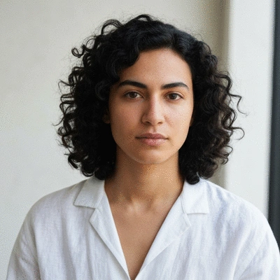 Person calmly holding a single CBD gummy, with a soft-focus background suggesting relaxation or a wellness setting, no text, no words, no typography