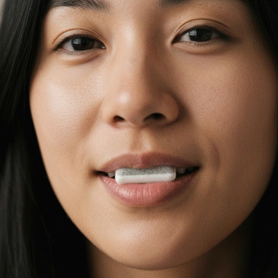 Person chewing CBD gum with a subtle, relaxed expression